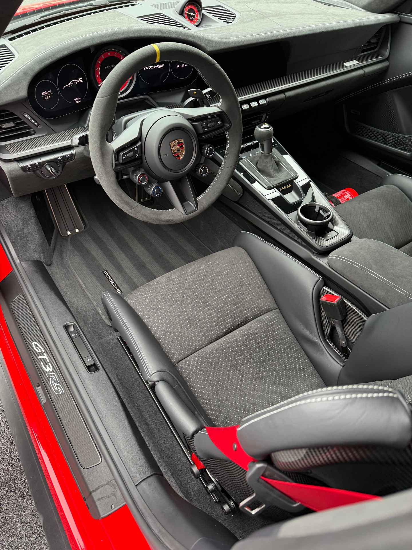 Detailed interior of a Porsche GT3 RS showing conditioned leather seats and Alcantara steering wheel